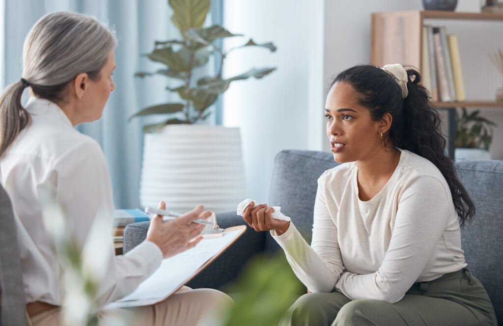 young woman conversing with a female psychotherapist
