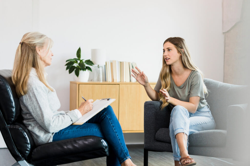 young female talking to a professional while undergoing a psychological evaluation