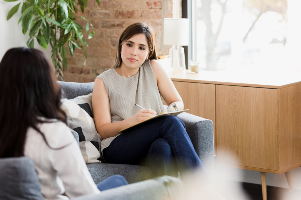 female participating in psychotherapy services while listening